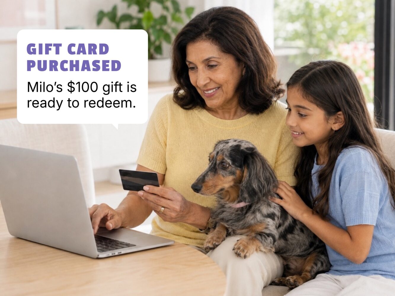Family reviewing an online pet booking on a laptop