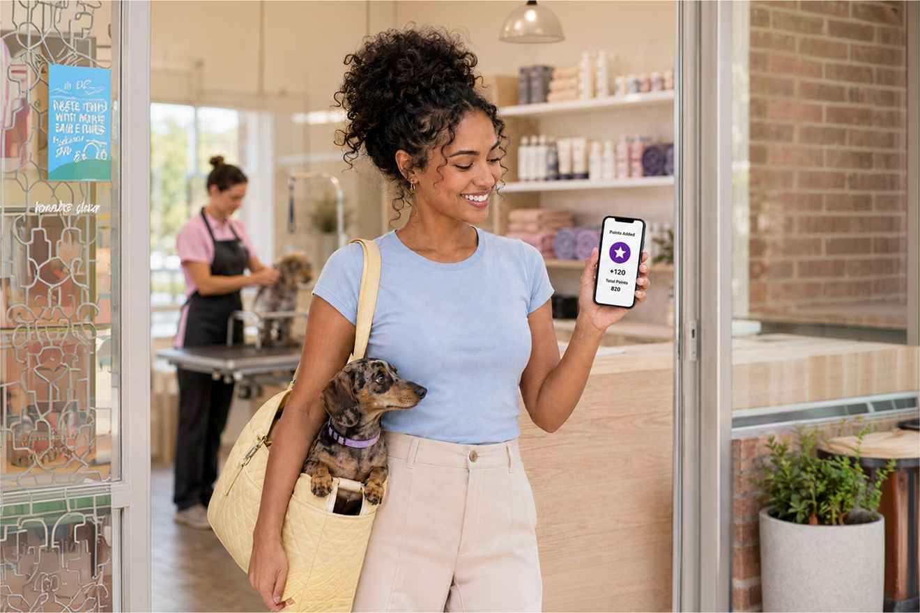 Pet owner using a phone in a grooming salon