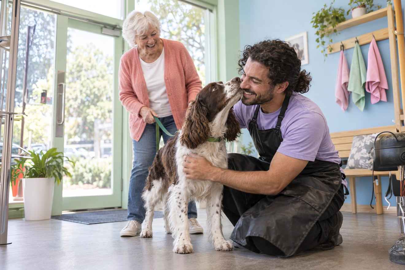 Pet groomer discussing care with a dog owner